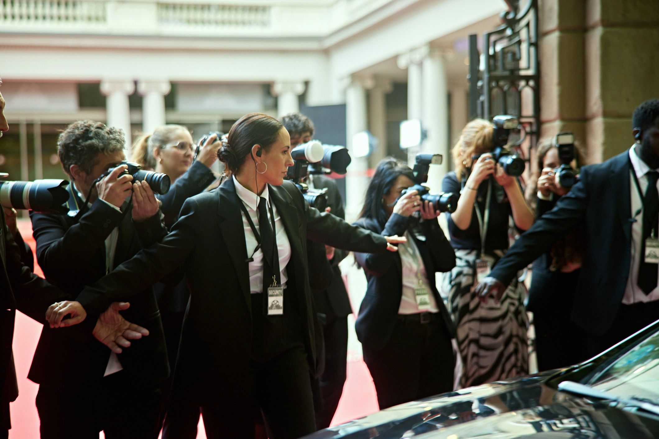 Red-carpet arrival scene representing high-touch event production and coordination