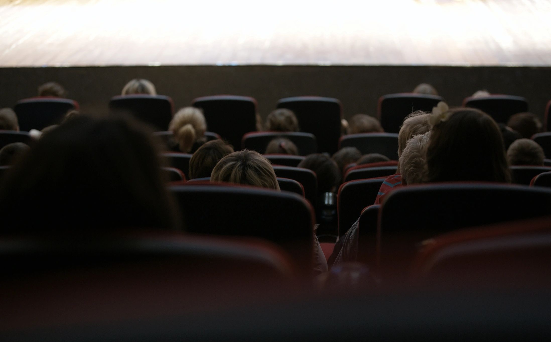 Guests watching a live stage performance with dramatic lighting